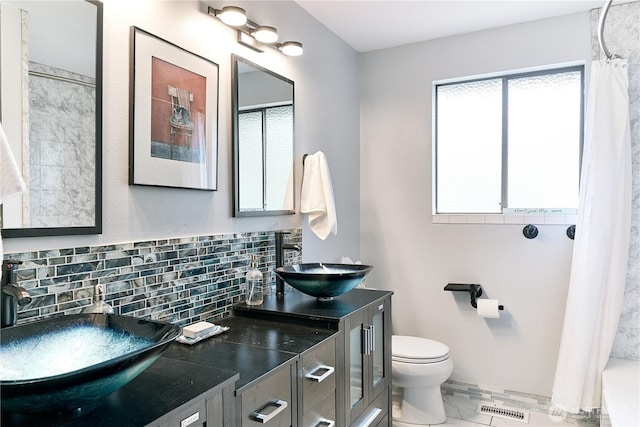 15722 62nd Pl NE, Kenmore, WA 98028 - bathroom featuring double vanity, backsplash, marble look tiles, and shower / bath combo