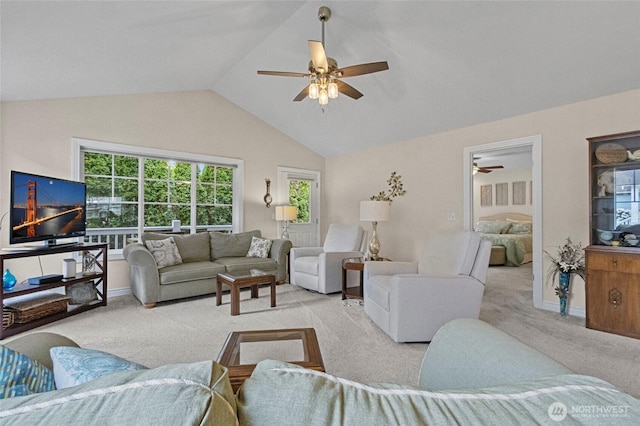 living area with baseboards, carpet, ceiling fan, and lofted ceiling