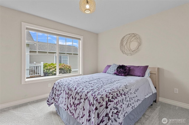 carpeted bedroom featuring baseboards