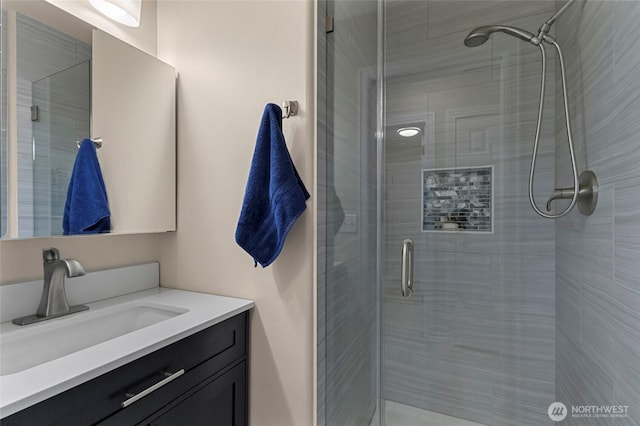 full bathroom featuring a shower stall and vanity