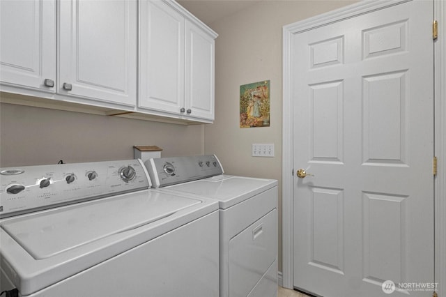 laundry area featuring separate washer and dryer and cabinet space
