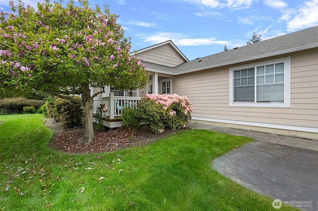 exterior space featuring a porch and a front yard