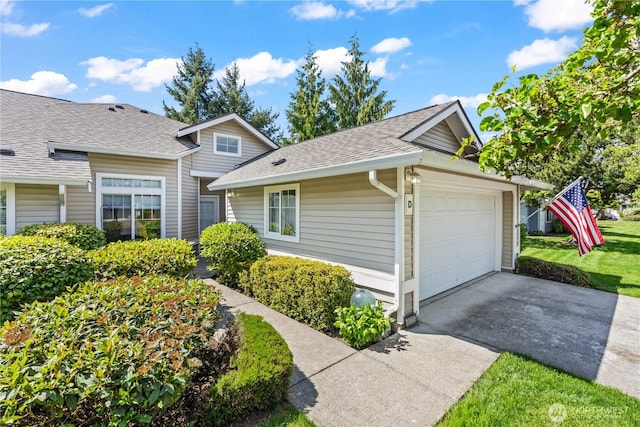 view of front of house with concrete driveway, a shingled roof, and a garage