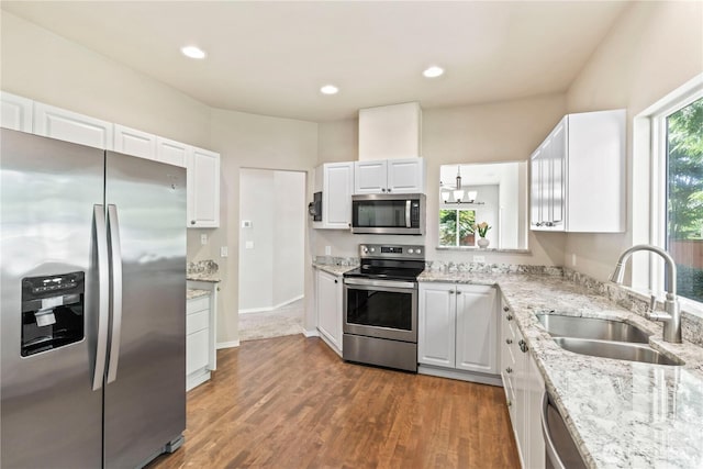 kitchen with stainless steel appliances, white cabinets, and a sink