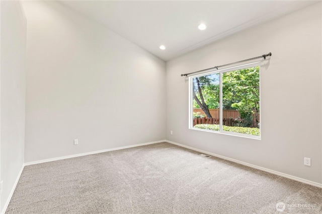 spare room with carpet floors, baseboards, visible vents, and recessed lighting