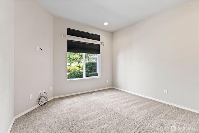unfurnished room featuring carpet flooring, baseboards, visible vents, and recessed lighting