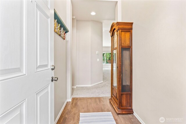 hall with baseboards, recessed lighting, and wood finished floors