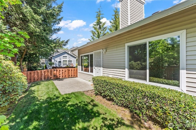 view of yard with a patio and fence