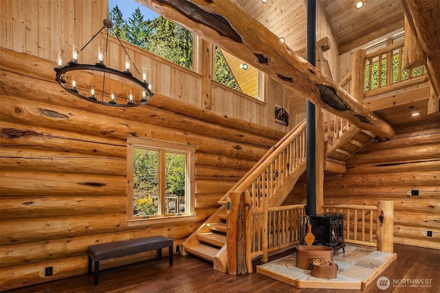 staircase with recessed lighting, wood ceiling, a wood stove, and hardwood / wood-style flooring