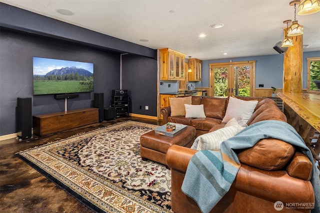 living room with recessed lighting, baseboards, french doors, and finished concrete floors