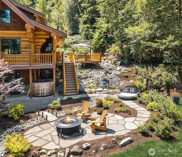 view of yard featuring stairway, a patio, a fire pit, and a wooden deck