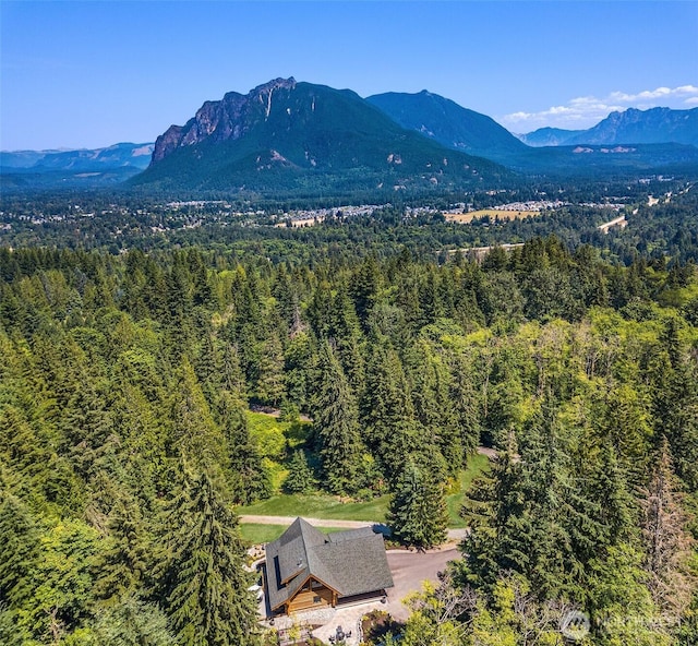 drone / aerial view with a mountain view and a wooded view