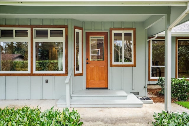 property entrance featuring board and batten siding