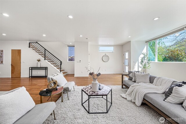 living room featuring recessed lighting, stairway, and light wood-type flooring
