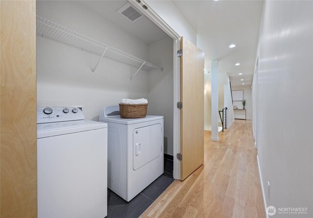 laundry area with laundry area, visible vents, washer and dryer, recessed lighting, and light wood-style flooring