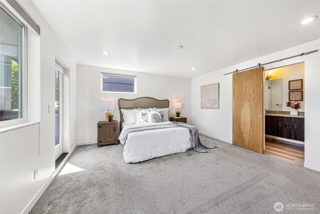 bedroom featuring baseboards, a barn door, carpet flooring, and recessed lighting
