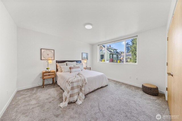 bedroom featuring baseboards and carpet flooring