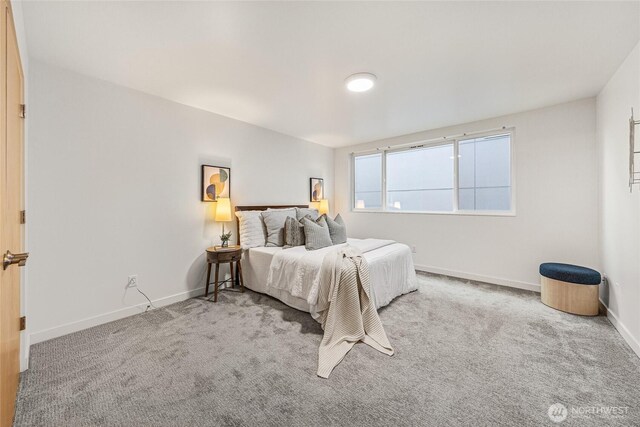 carpeted bedroom featuring baseboards