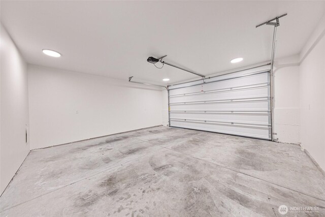 garage featuring recessed lighting and a garage door opener