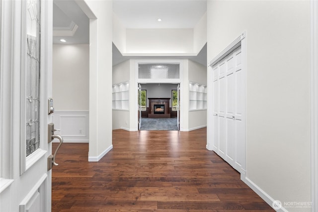 23615 38th Ave E, Spanaway, WA 98387 - entryway featuring dark wood-type flooring, a glass covered fireplace, and baseboards