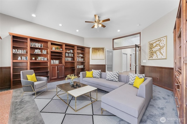 23615 38th Ave E, Spanaway, WA 98387 - living room with a wainscoted wall, a ceiling fan, recessed lighting, light colored carpet, and wooden walls