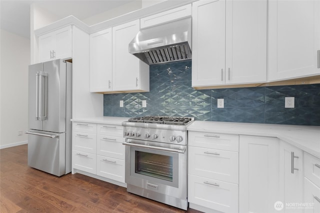 23615 38th Ave E, Spanaway, WA 98387 - kitchen featuring high end appliances, wall chimney range hood, backsplash, and dark wood-type flooring