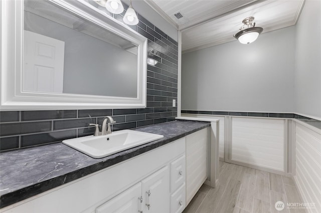 23615 38th Ave E, Spanaway, WA 98387 - bathroom with vanity, ornamental molding, and tasteful backsplash
