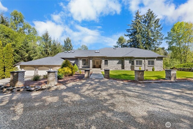 23615 38th Ave E, Spanaway, WA 98387 - view of front of home with a garage, a front lawn, and concrete driveway