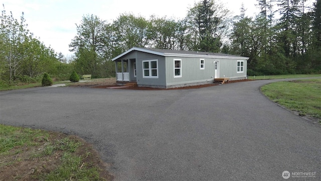 manufactured / mobile home with aphalt driveway, crawl space, and entry steps