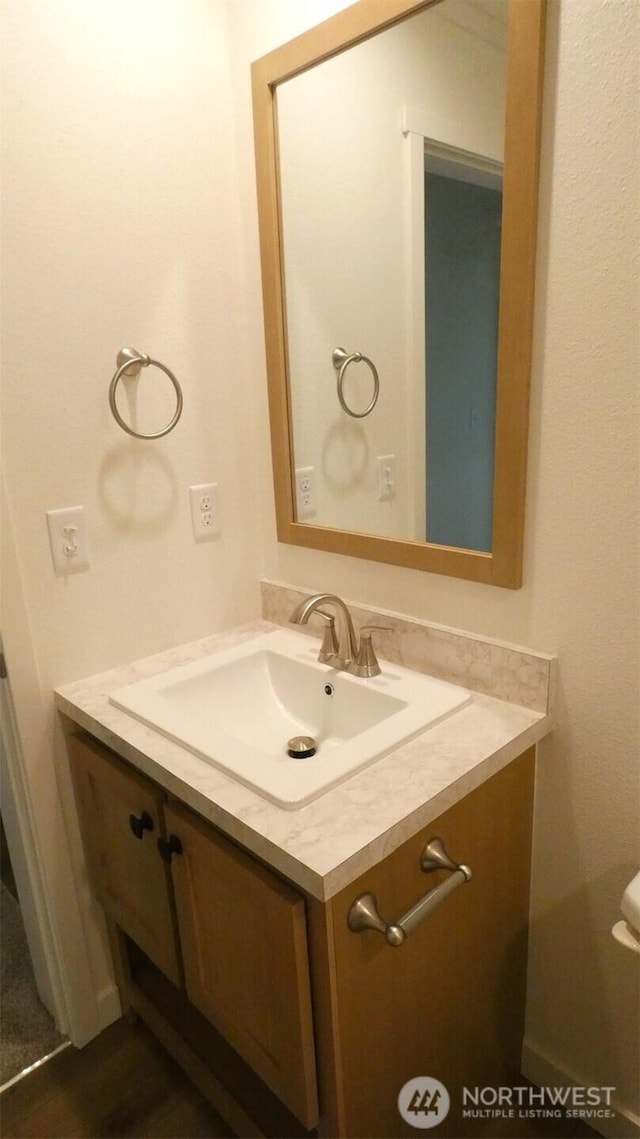 half bathroom featuring vanity