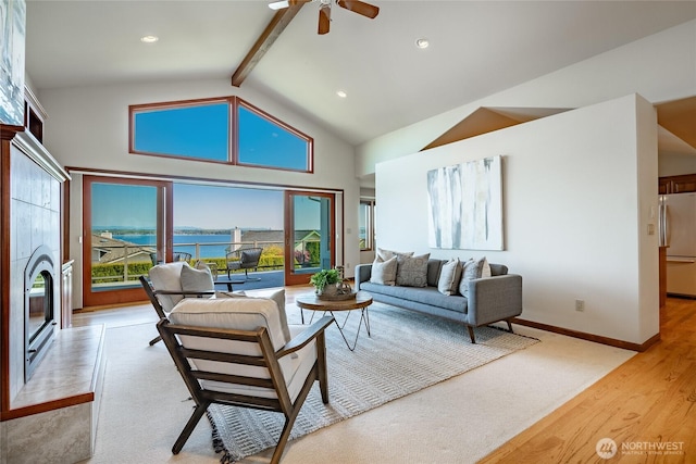 8022 Makah Rd, Blaine, WA 98230 - living area with ceiling fan, light wood finished floors, high vaulted ceiling, a water view, and beamed ceiling