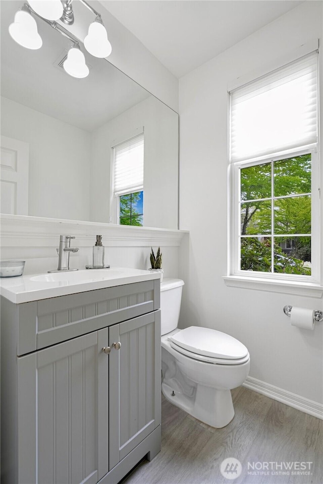 1741 12th Ave NE, Issaquah, WA 98029 - bathroom with vanity, an inviting chandelier, wood finished floors, toilet, and baseboards