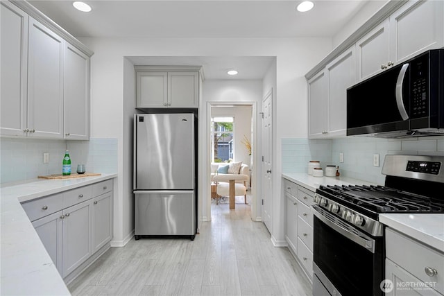 1741 12th Ave NE, Issaquah, WA 98029 - kitchen with recessed lighting, decorative backsplash, light wood finished floors, and stainless steel appliances