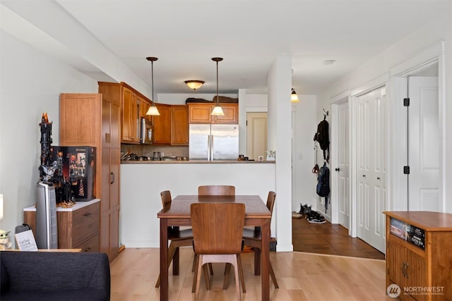 dining area featuring light wood-style floors