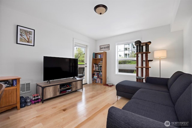 living room featuring wood finished floors and visible vents
