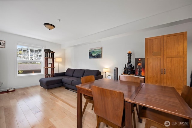dining area with baseboards and light wood-type flooring