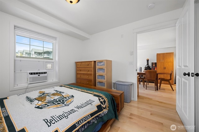 bedroom featuring light wood-type flooring and cooling unit