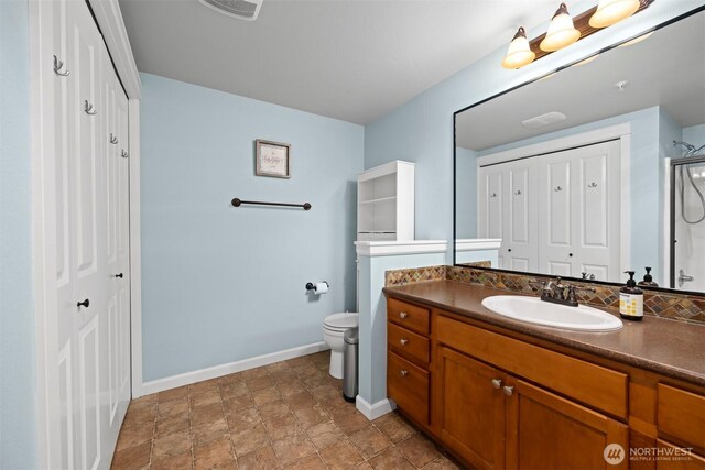 full bath with a closet, baseboards, and toilet