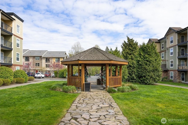 surrounding community with a gazebo, a yard, and a residential view