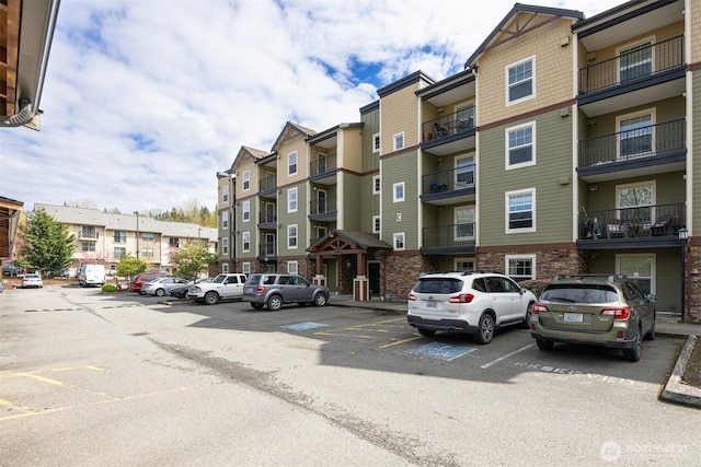 view of building exterior with uncovered parking