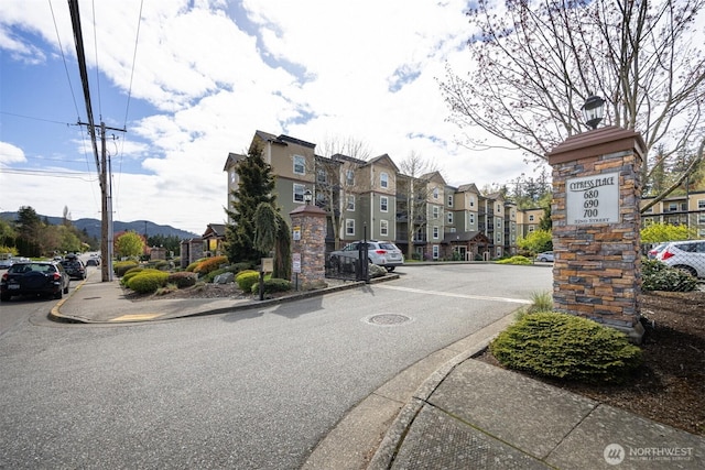 view of street featuring a residential view, sidewalks, and curbs