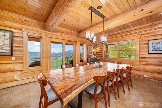 tiled dining space with wooden ceiling, a mountain view, beam ceiling, and a chandelier