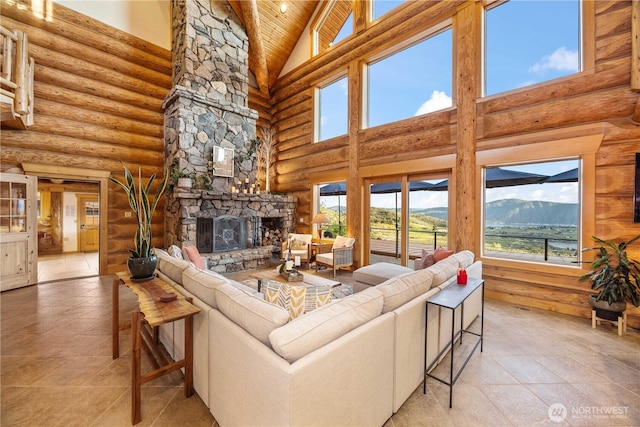 tiled living area with plenty of natural light, log walls, a stone fireplace, and high vaulted ceiling