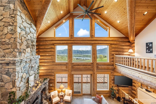 living area featuring recessed lighting, high vaulted ceiling, wood ceiling, and rustic walls