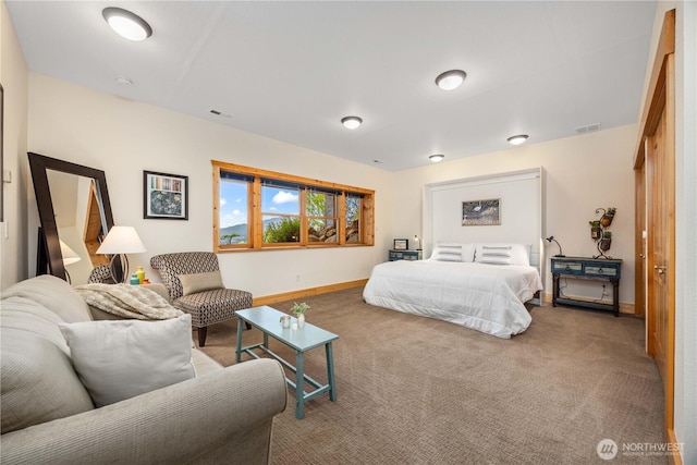carpeted bedroom with baseboards and visible vents