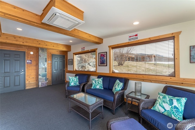 carpeted living area with recessed lighting, wooden walls, and beamed ceiling