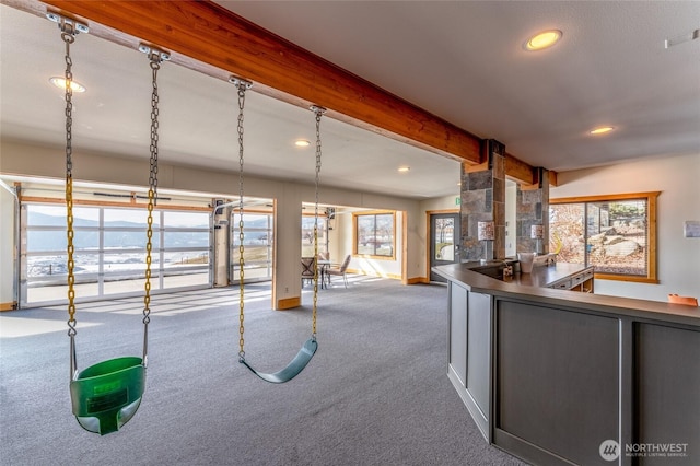 interior space with carpet flooring, recessed lighting, baseboards, and beamed ceiling