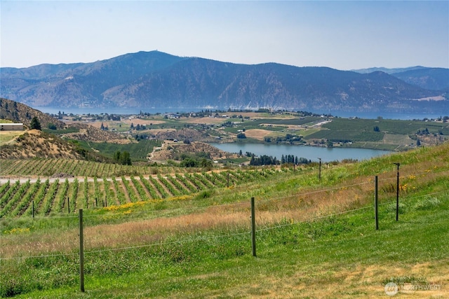 view of mountain feature featuring a water view and a rural view
