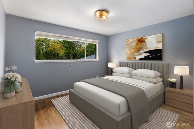 bedroom with baseboards and wood finished floors