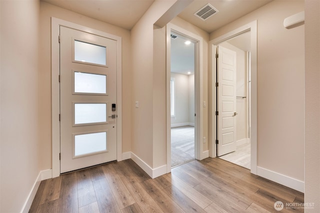 entryway with visible vents, baseboards, and hardwood / wood-style flooring